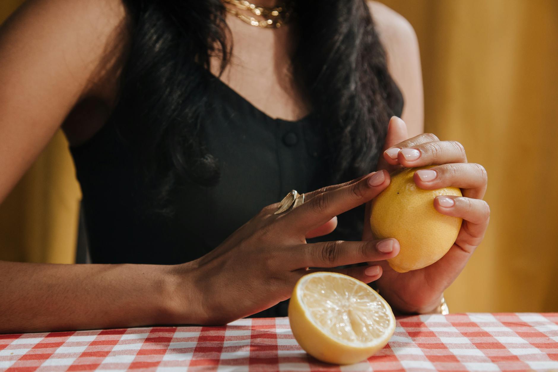 Woman holding a pink clitoral vibrator with focus and intention