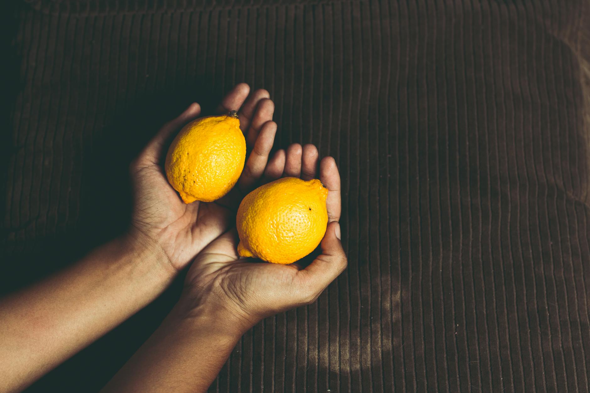 Bright ripe lemons composed on yellow background