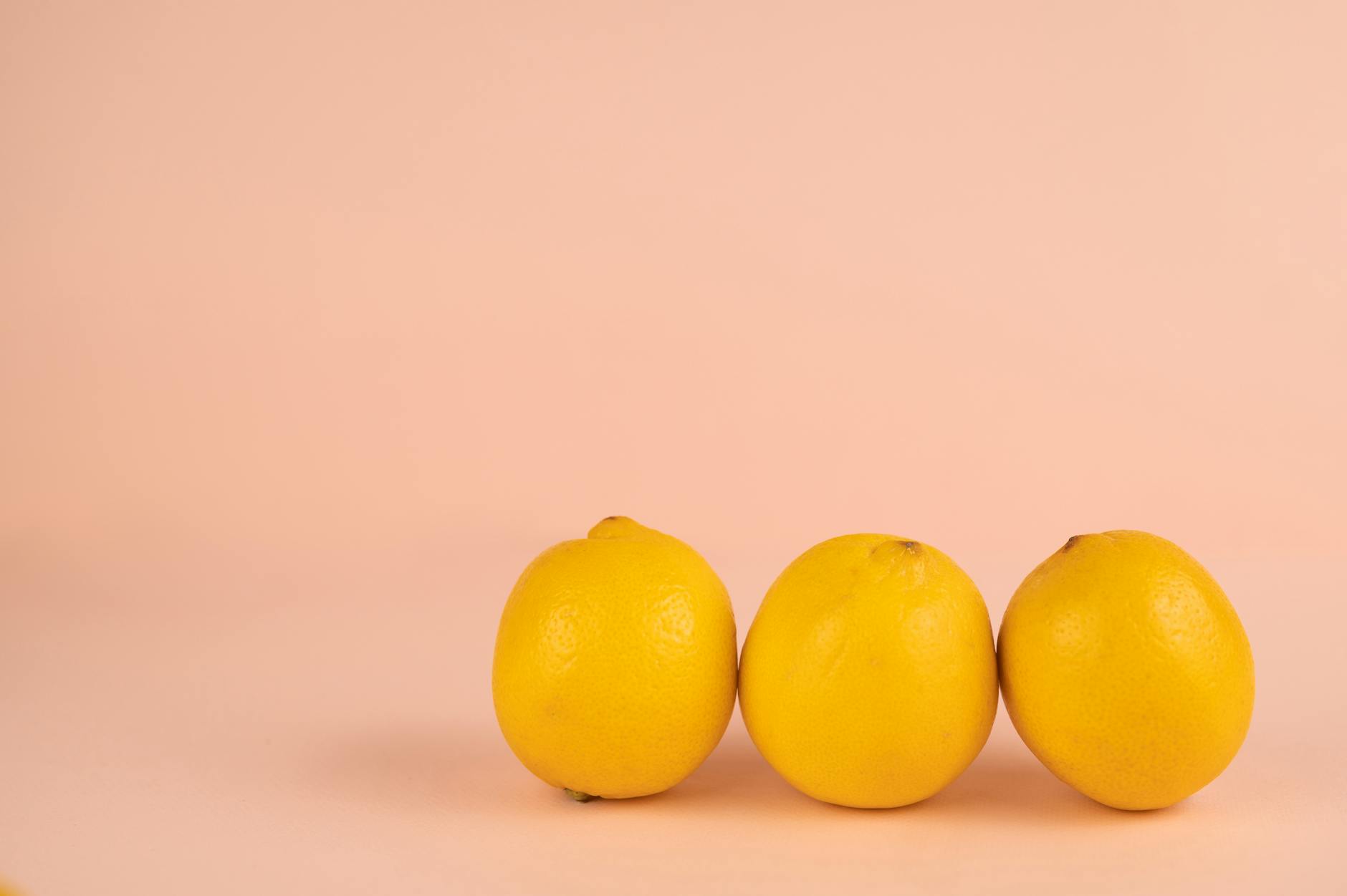 Bright ripe lemons arranged on a soft pastel background, symbolizing fresh pleasure and renewed vitality